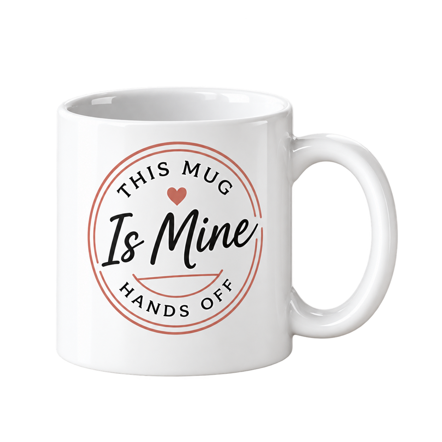 White mug with a rose-colored circle and the words This Mug Is Mine and Hands Off.